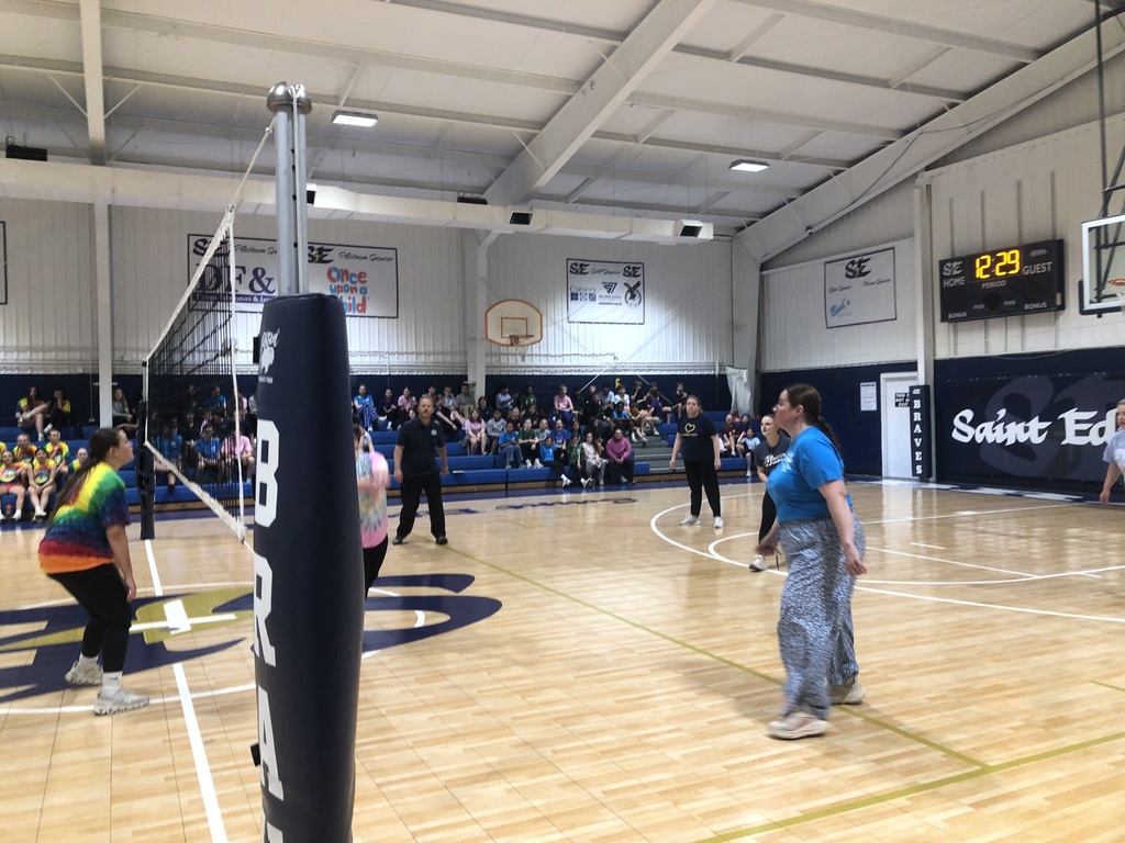 Faculty team preparing for a rally at the net.