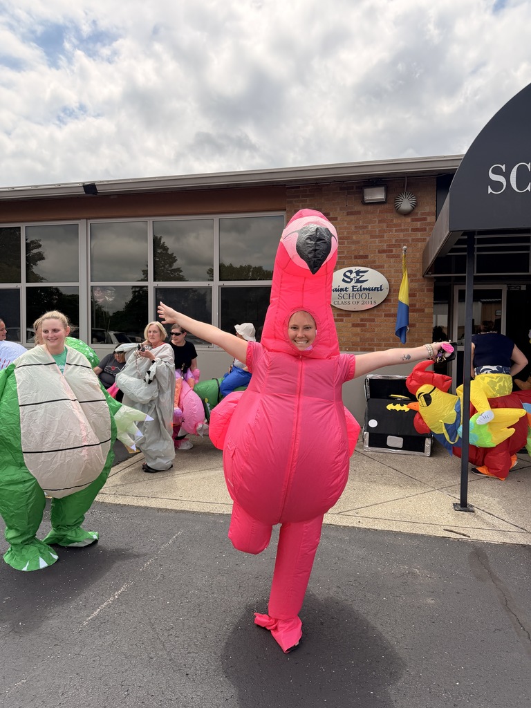 Staff member wearing a pink flamingo inflatable costume.