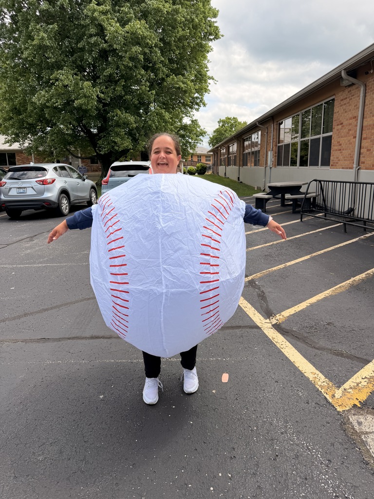 Staff member wearing an inflatable baseball costume.