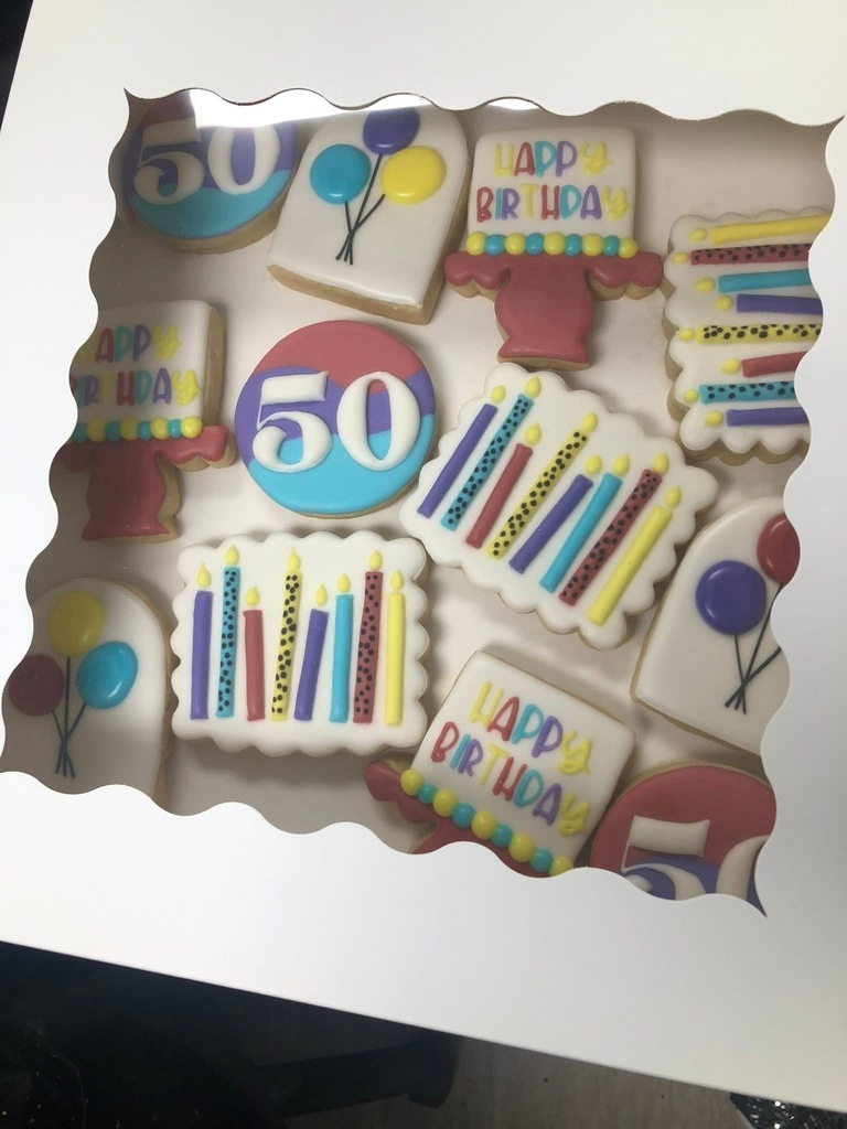 Decorated birthday cookies with “50” and colorful birthday designs.