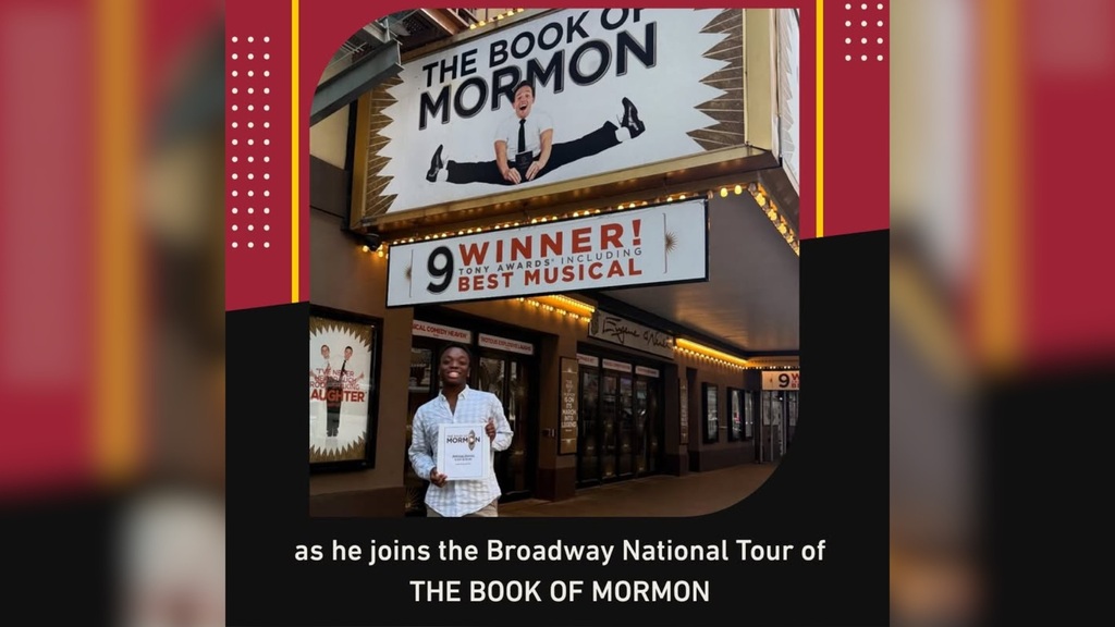 Ade Goring stands outside The Book of Mormon theater marquee, celebrating his role in the Broadway National Tour.
