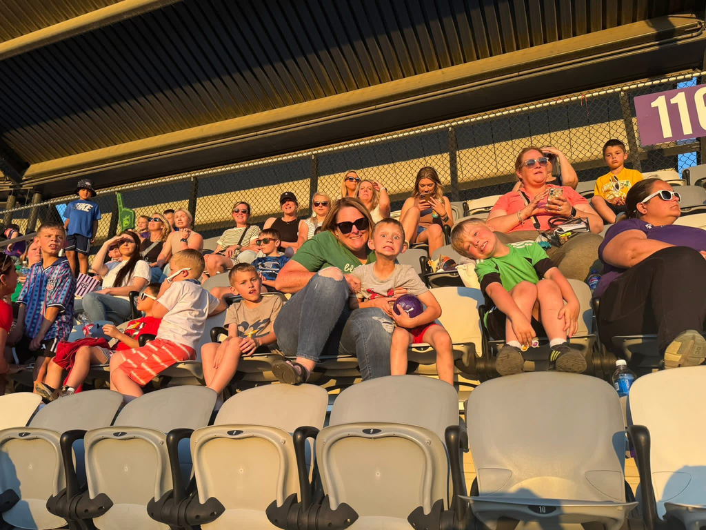 St. Edward mothers and sons enjoying the game from the stadium seats.