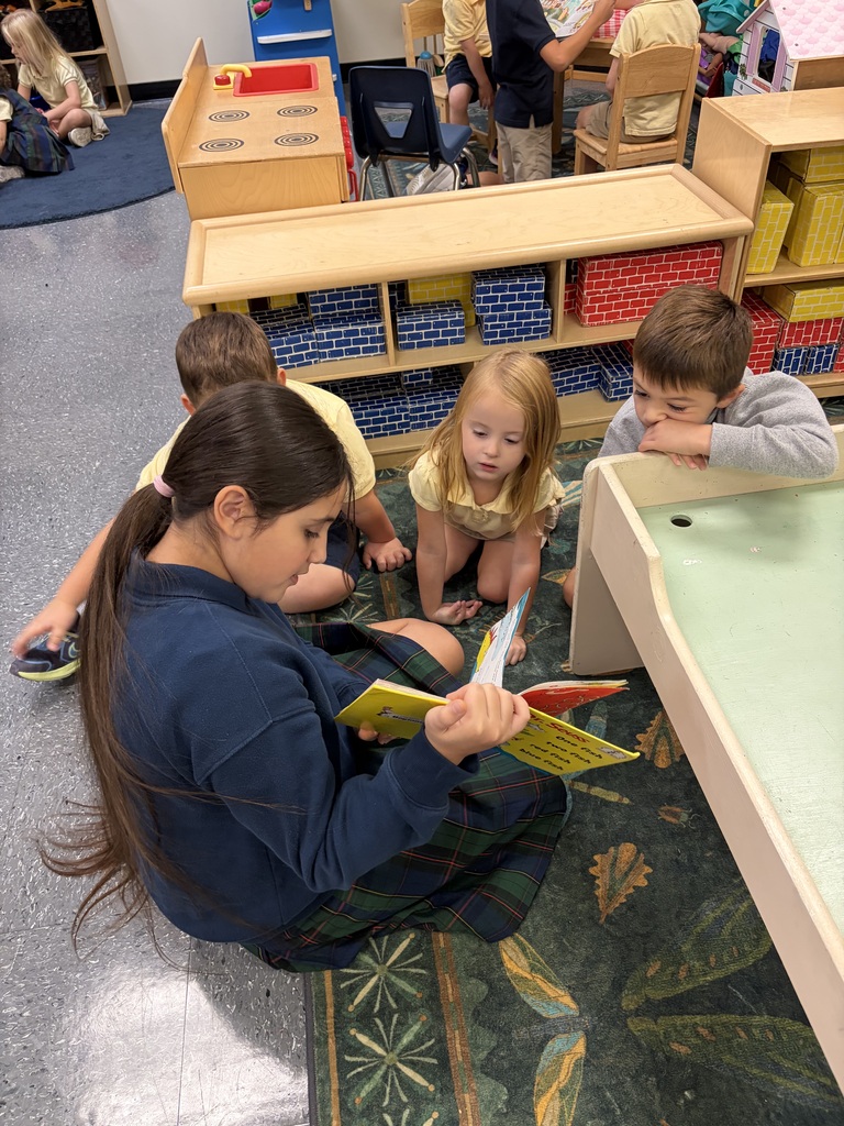 Older students read picture books with preschool students during Brave Buddies, sharing time together in the classroom and building friendships through reading.