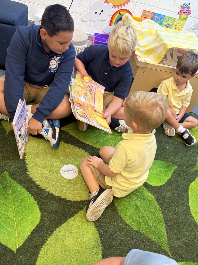 Older students read picture books with preschool students during Brave Buddies, sharing time together in the classroom and building friendships through reading.