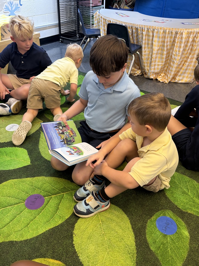 Older students read picture books with preschool students during Brave Buddies, sharing time together in the classroom and building friendships through reading.