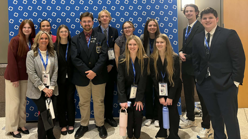 group of DECA students and advisor