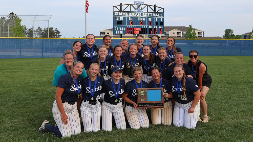 Team photo with scoreboard in background