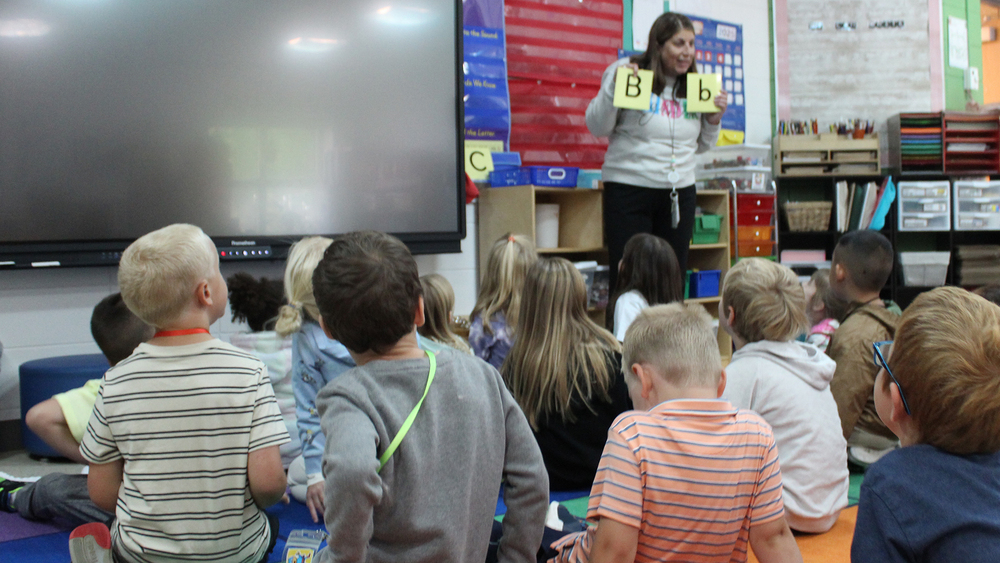 kindergarten classroom with teacher at he front of the room
