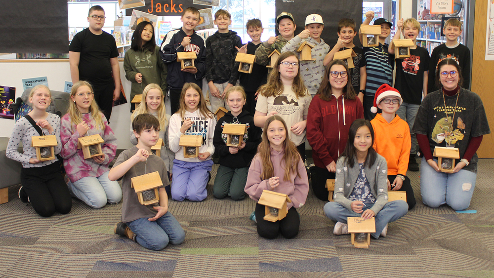 class showing off their bird feeders