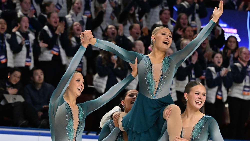 Aleksa being held up by her teammates in a competition