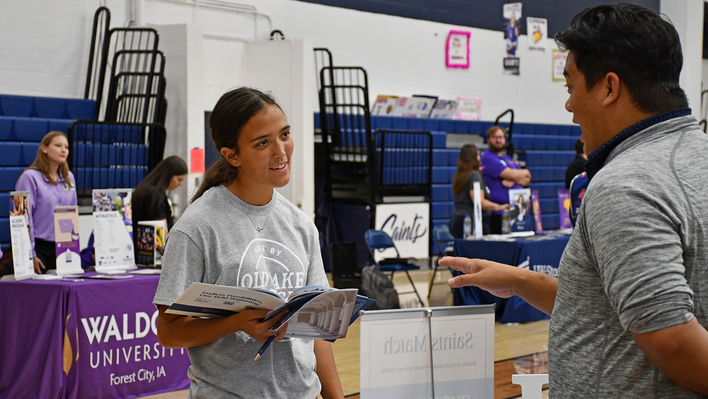 student listening to a college rep