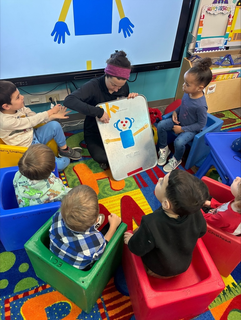 Students sit around the OT while she builds Mat Man.