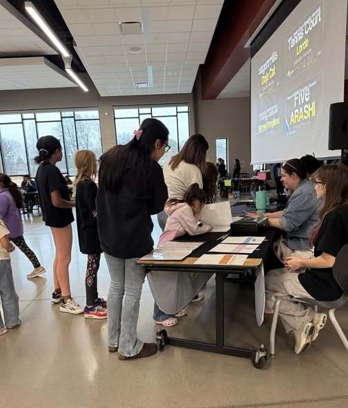 Participants looking over possible songs at Kids Karaoke Night