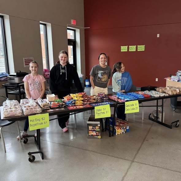 Snack table with volunteers at Kids Karaoke Night