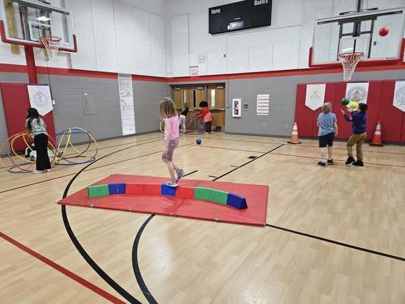 student working on balance beam