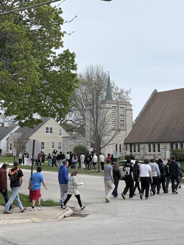 Students and staff cross the street to their designated reunification location. 
