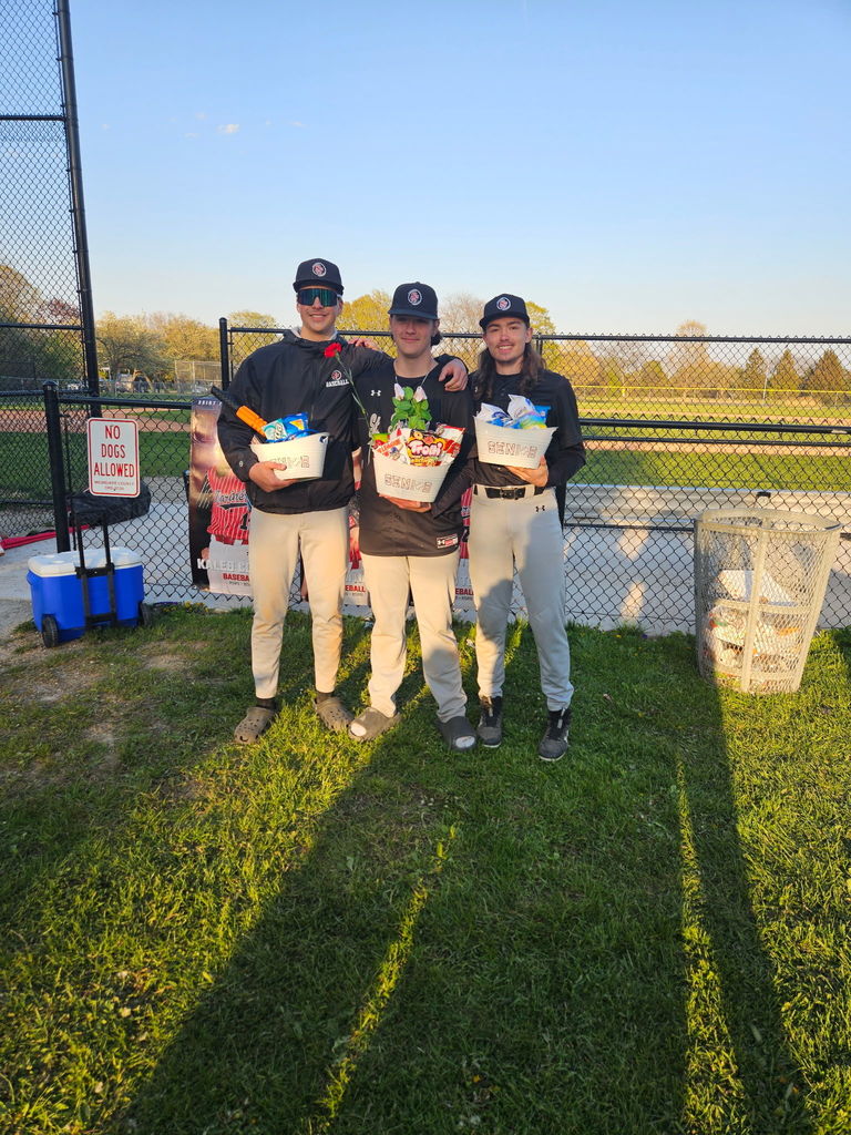 Senior Night baseball with  all 3 seniors behind the bench holding their appreciation baskets