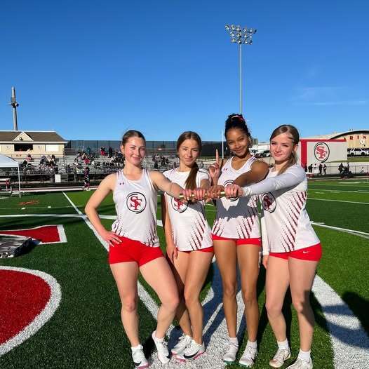 Record breaking girls relay team shown after they broke school record
