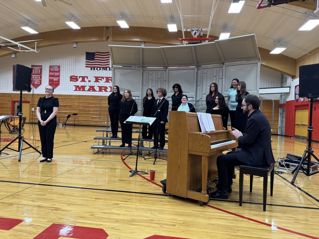 Students stand on risers during their performance.