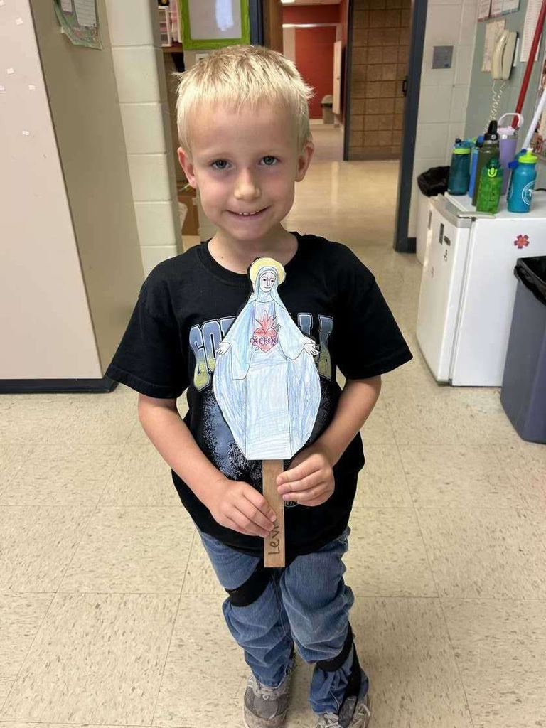 child holding Mother Mary image