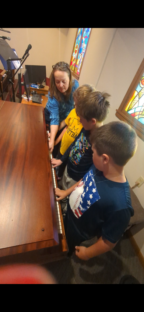 Mrs. Johnson teaching piano lessons at St. John Paul II School