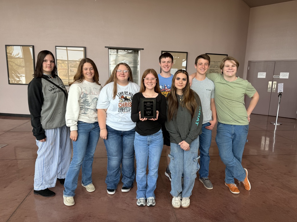 Students holding their plaque of Superior achievement at the NPC Large Group Festival.