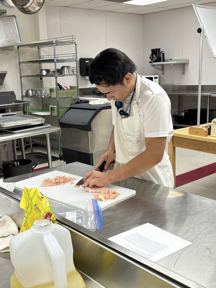 Larry cutting chicken