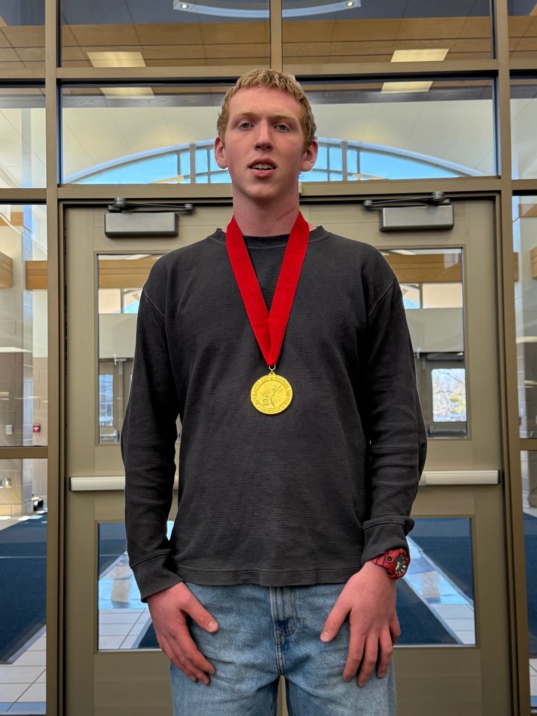 Ronan poses with his medal for earning the Gold Key Scholastic Art Award