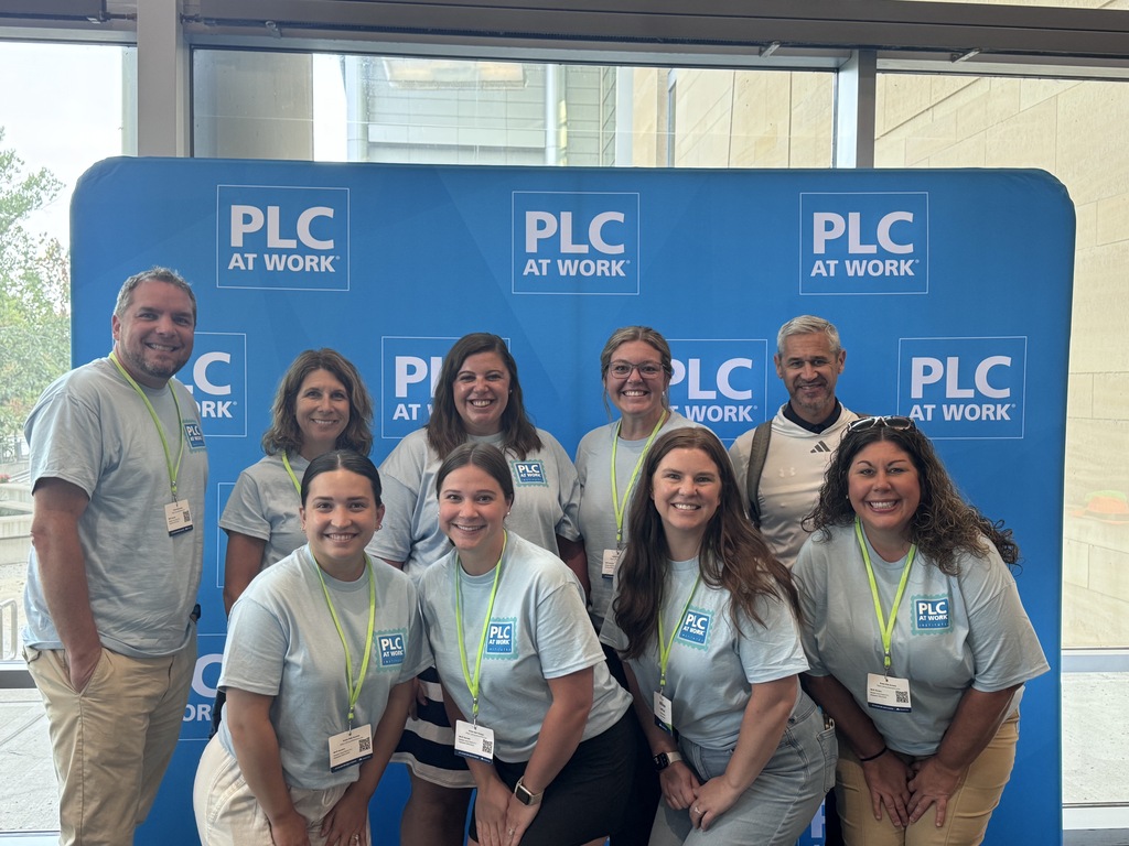 Staff posing for a picture at the PLC conference in Grand Rapids