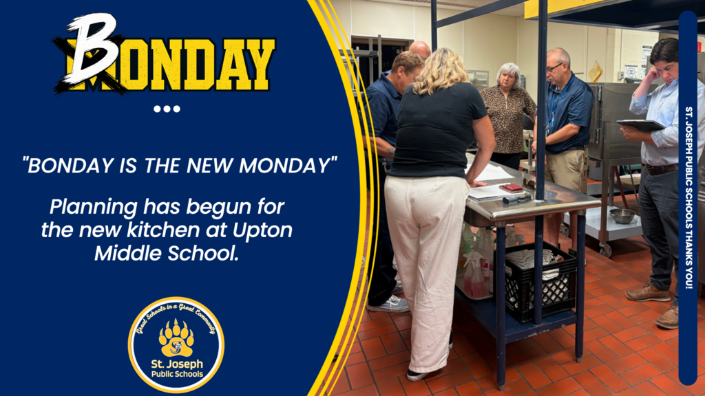 Members of the Bond planning team look at drawings in the Upton Middle School Kitchen.