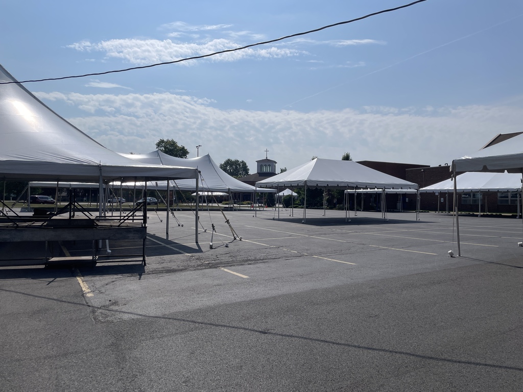 Empty picnic tents with St. Mary's church spire in the background