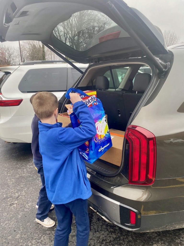 students carrying items for the HSA Lent Service Project