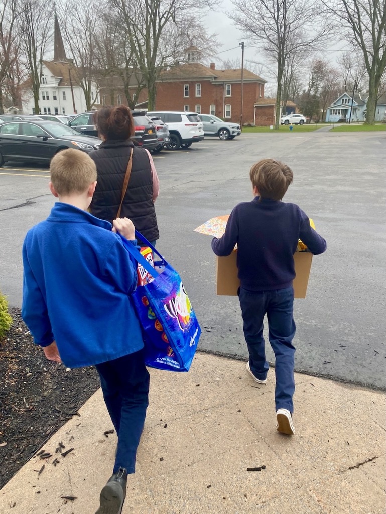 students carrying items for the HSA Lent Service Project