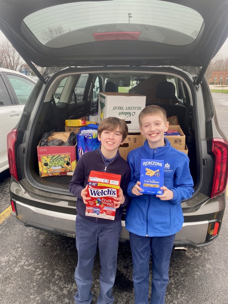 students carrying items for the HSA Lent Service Project