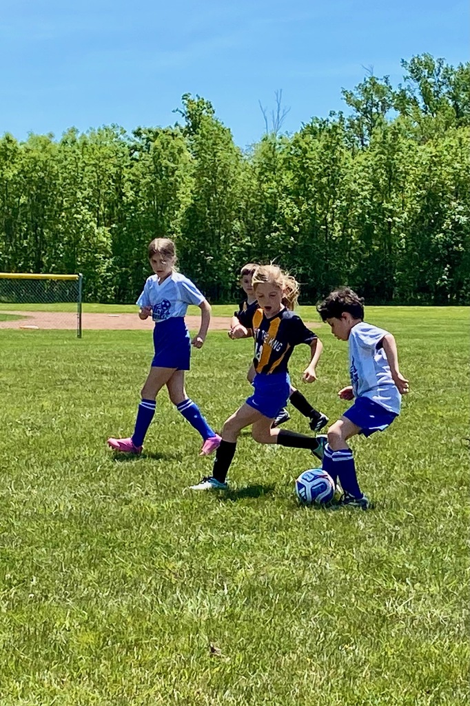 Grades 1 & 2 students playing soccer for St. Mary School Swormville