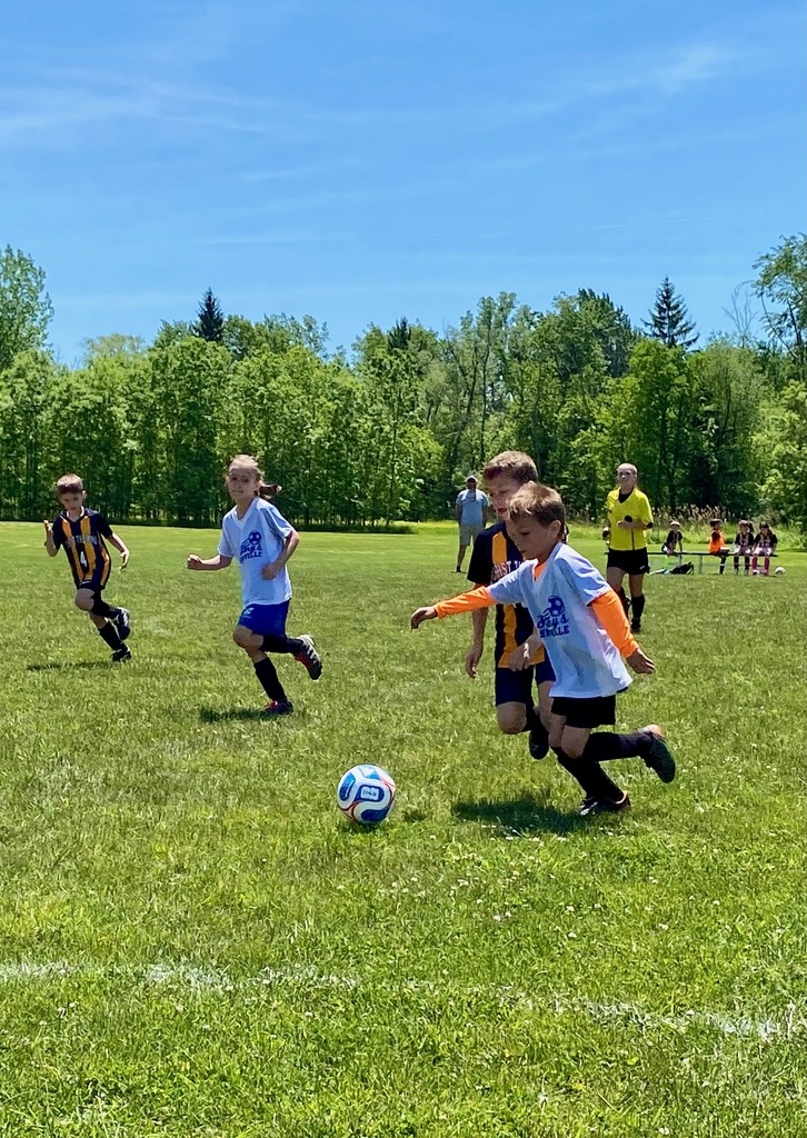 Grades 1 & 2 students playing soccer for St. Mary School Swormville