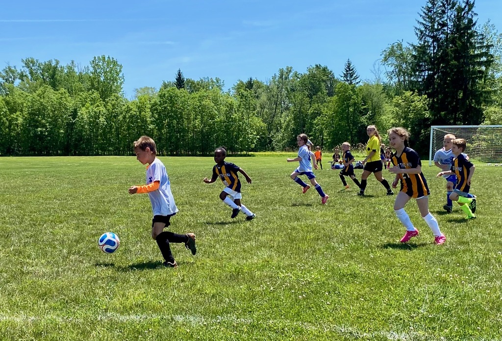 Grades 1 & 2 students playing soccer for St. Mary School Swormville