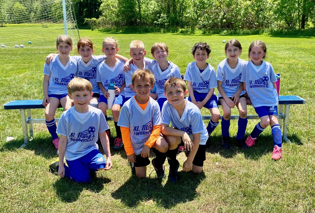 Grades 1 & 2 students playing soccer for St. Mary School Swormville