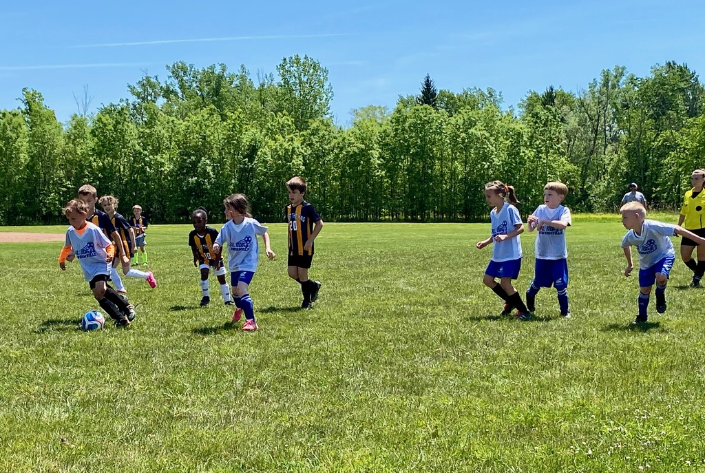 Grades 1 & 2 students playing soccer for St. Mary School Swormville