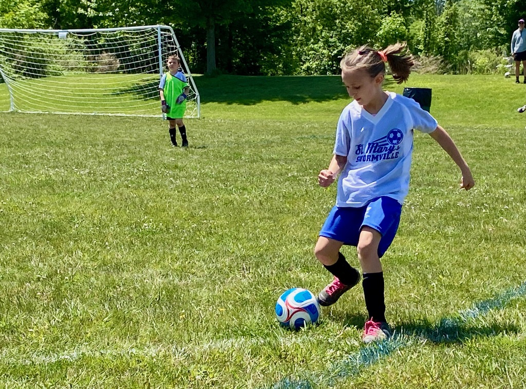 Grades 1 & 2 students playing soccer for St. Mary School Swormville