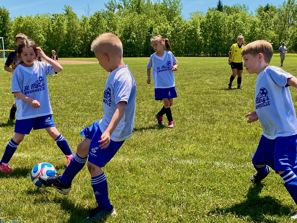 Grades 1 & 2 students playing soccer for St. Mary School Swormville