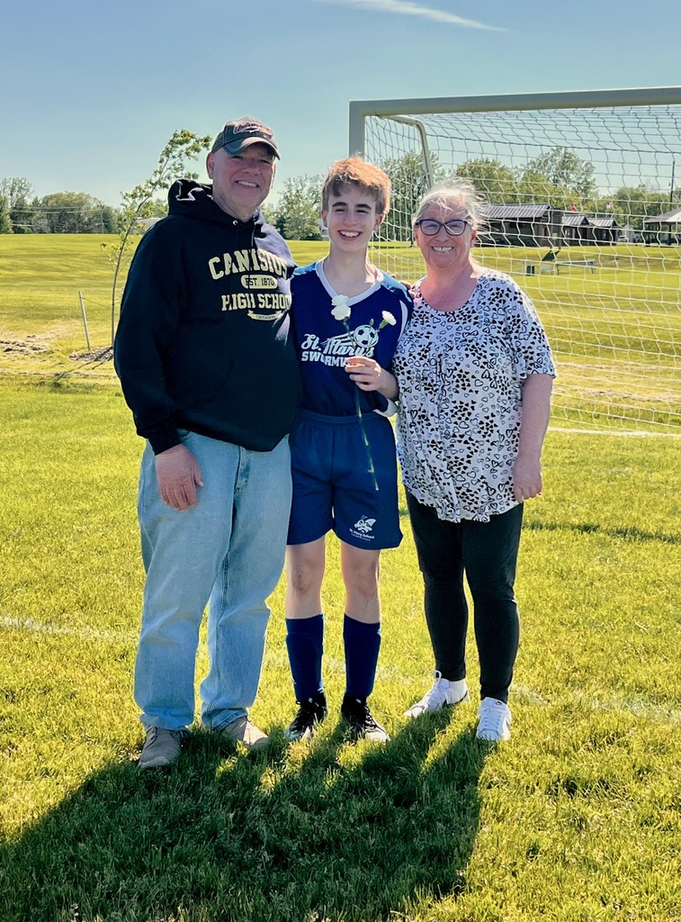 grade 8 soccer player student poses with parents