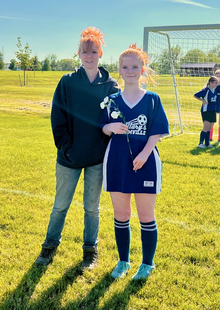 grade 8 soccer player student poses with parents