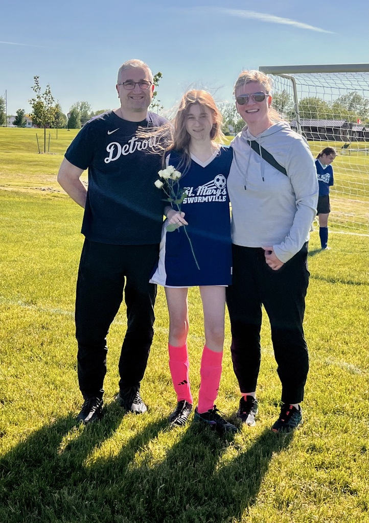grade 8 soccer player student poses with parents