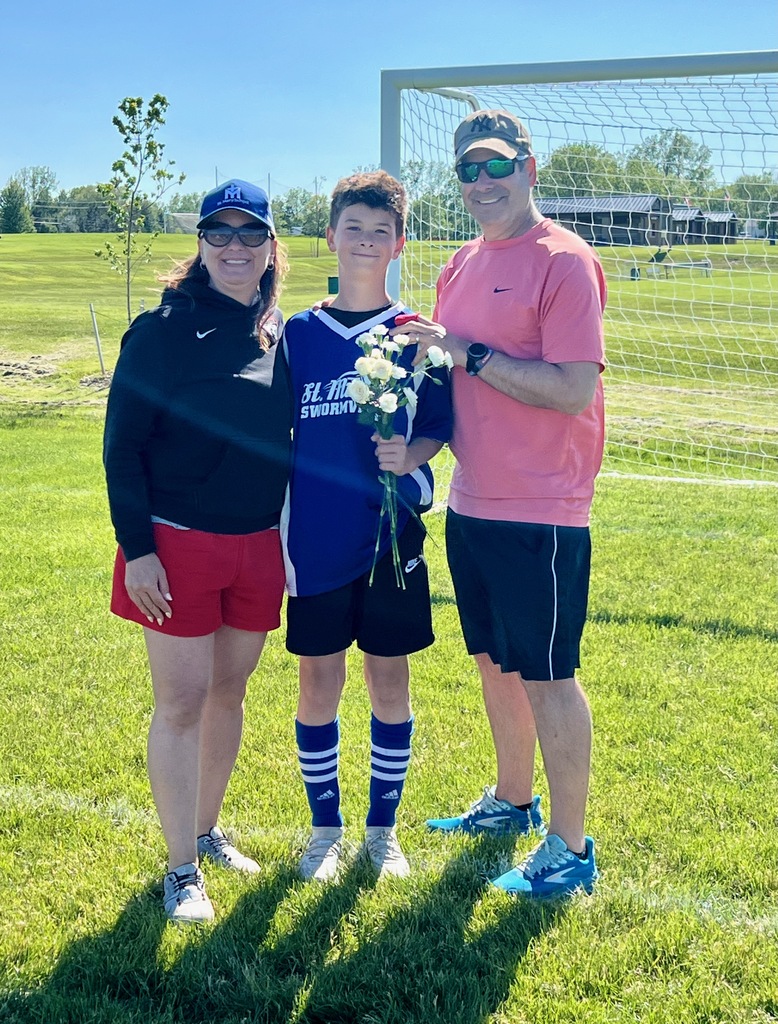grade 8 soccer player student poses with parents