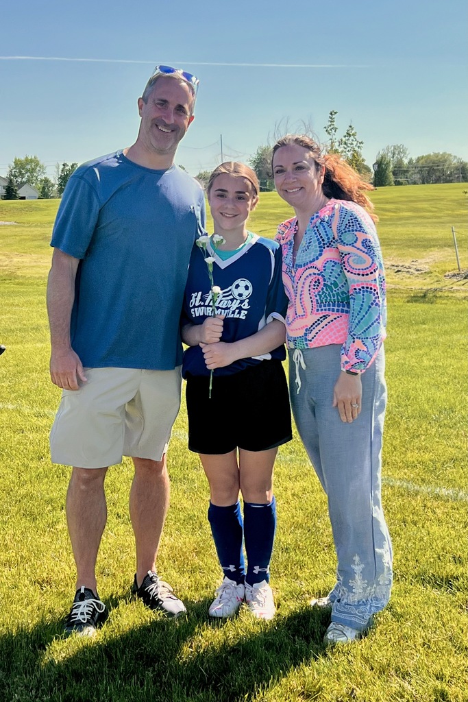 grade 8 soccer player student poses with parents