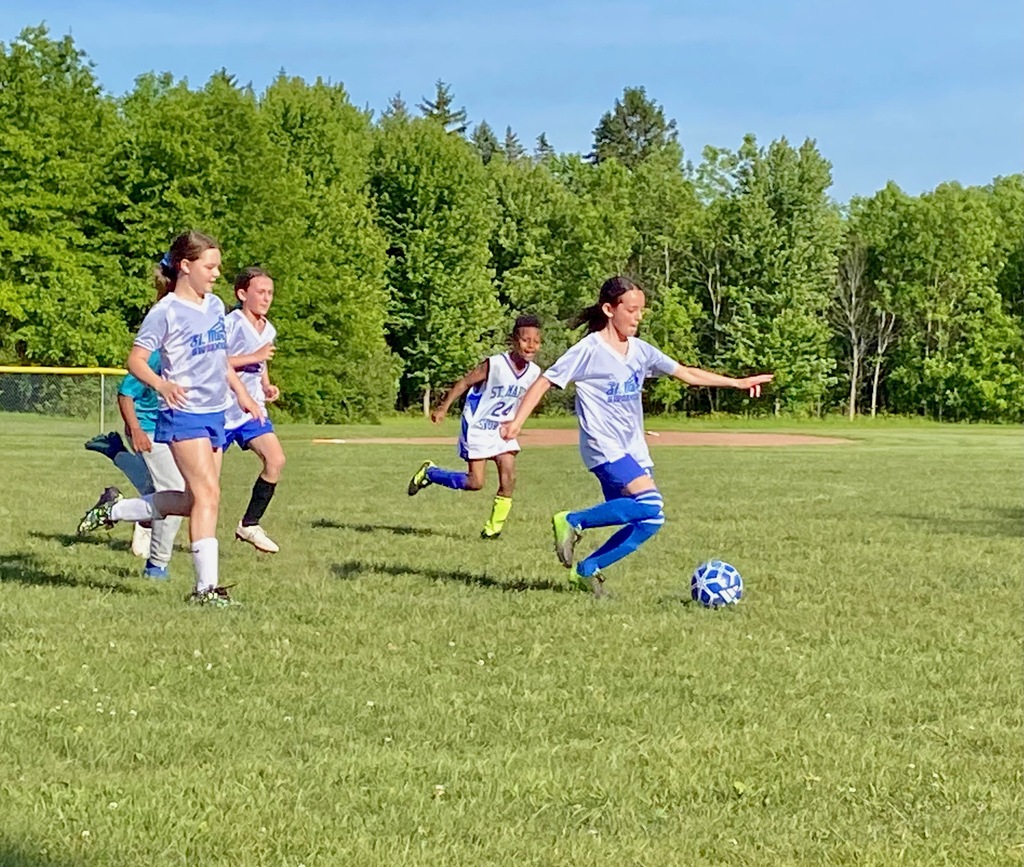 SMS grade 3 & 4 soccer players on the field during their last game of the season