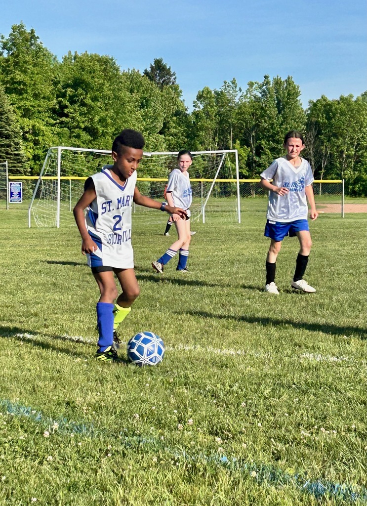 SMS grade 3 & 4 soccer players on the field during their last game of the season