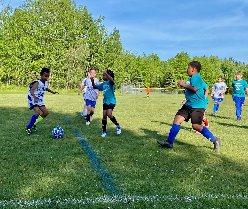 SMS grade 3 & 4 soccer players on the field during their last game of the season