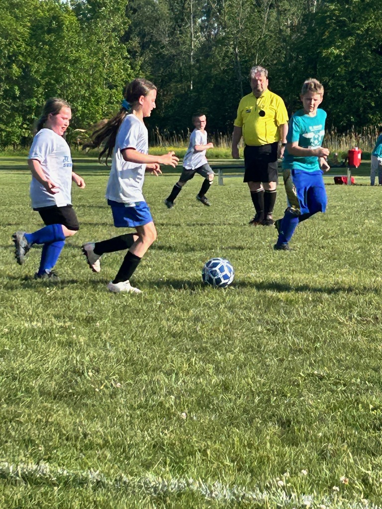 SMS grade 3 & 4 soccer players on the field during their last game of the season